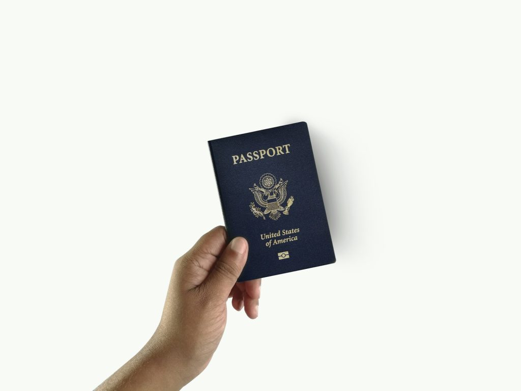 Hand holding a passport, representing UAE residence visa validity while staying abroad