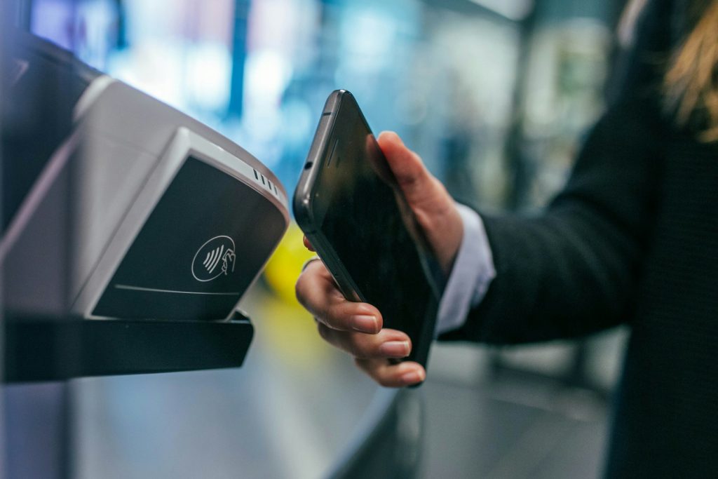 Contactless mobile payment at a card terminal, representing Aani instant payments and Jaywan cards in the UAE