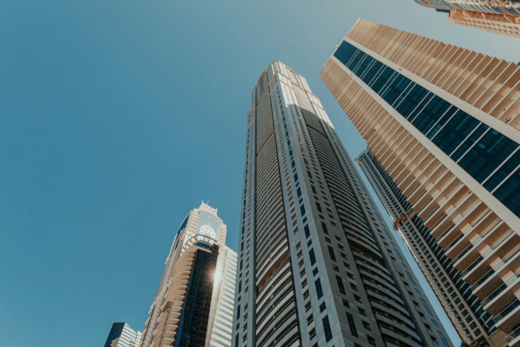 Modern free zone office towers seen from below against a clear sky