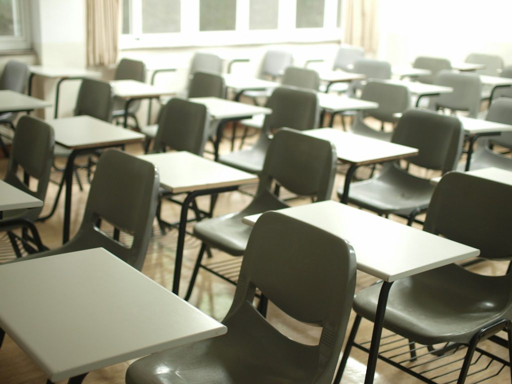 Empty classroom with desks and chairs, illustrating school suspension and expulsion rules in the UAE