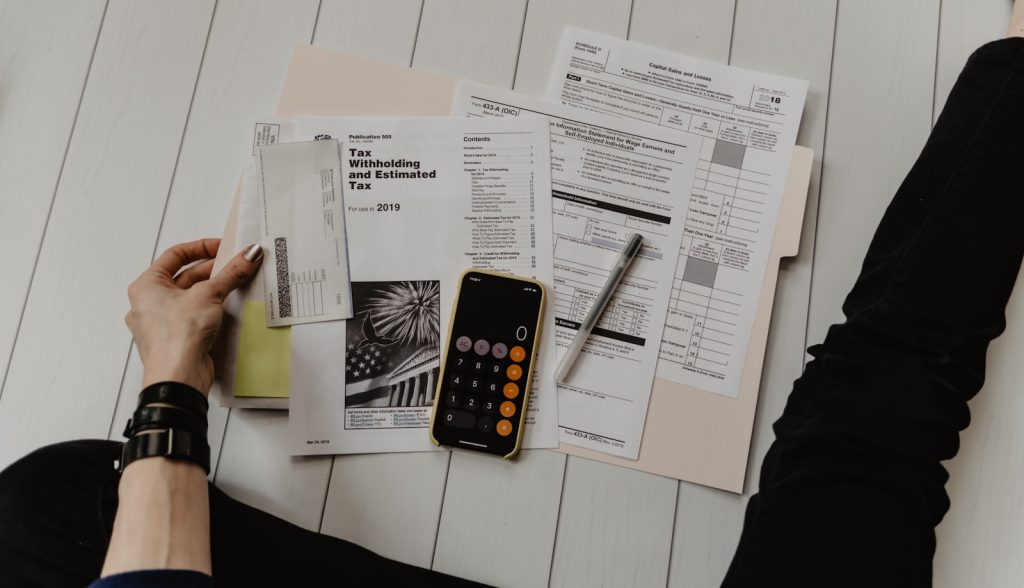 Bank statement, calculator and pen illustrating UAE Central Bank retail banking fee caps