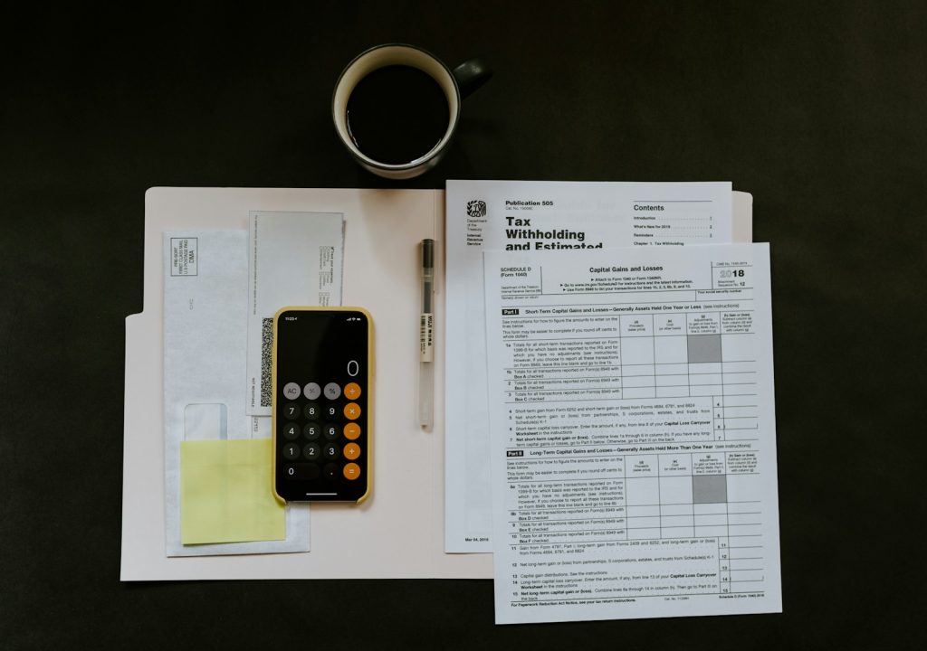 Tax paperwork and a folder on a desk, illustrating UAE VAT deregistration through EmaraTax