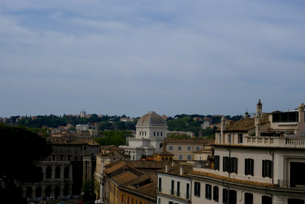 Rooftops and domes of Rome under a blue sky