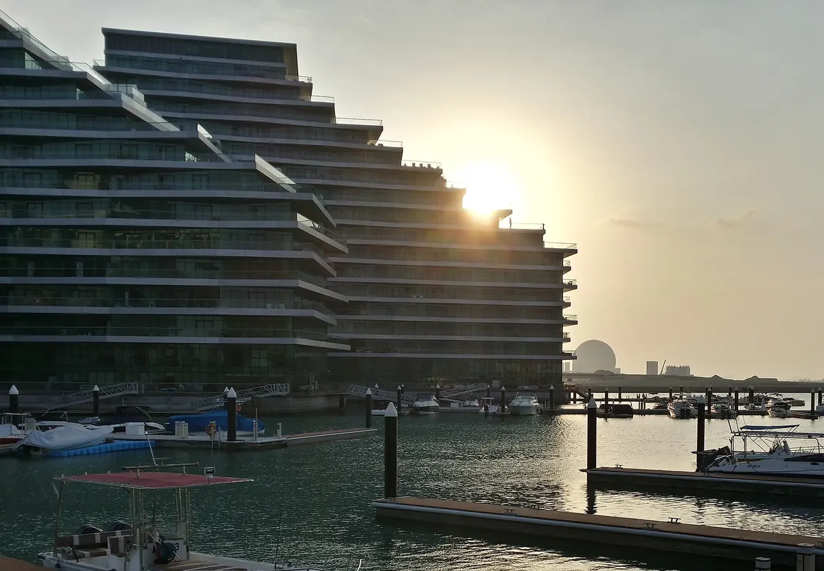 Al Bandar waterfront apartment buildings and marina at Al Raha Beach, Abu Dhabi, at sunset