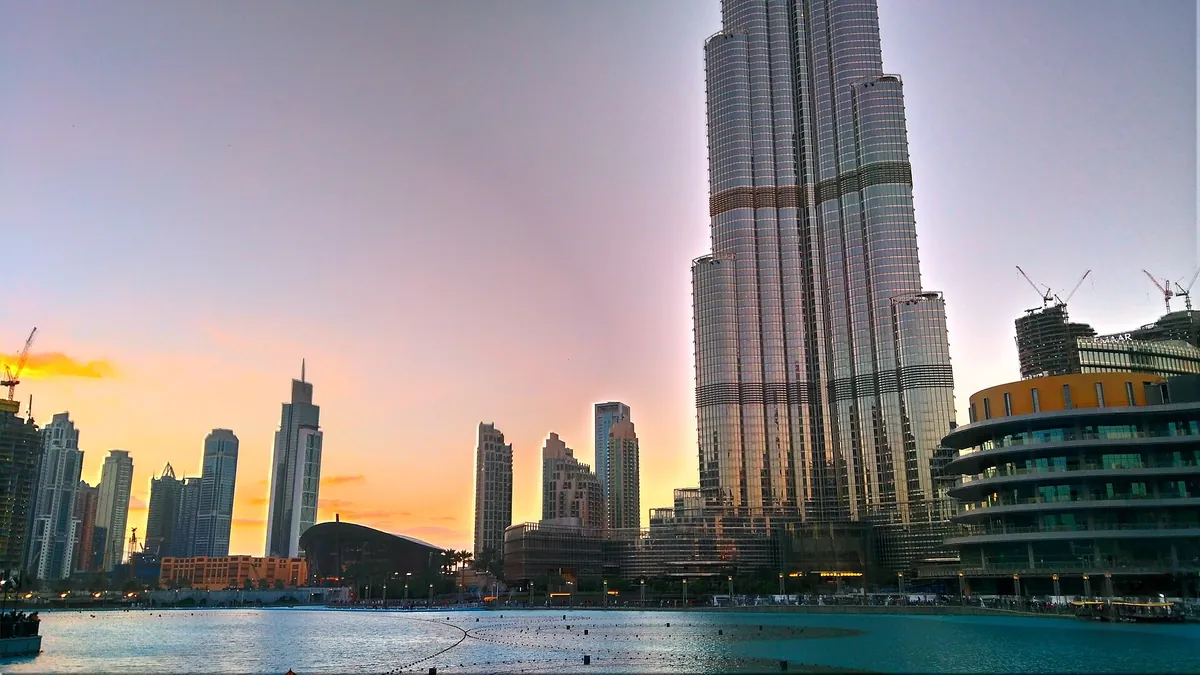 Burj Khalifa and the Dubai Fountain at sunset in Emaar's Downtown Dubai